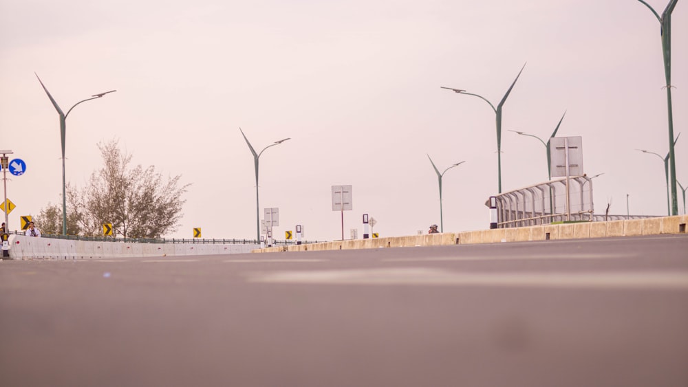 a group of street lights sitting next to a road