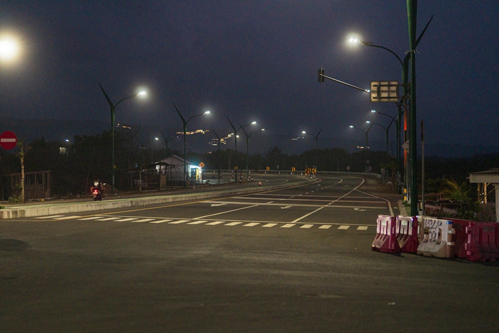 an empty street at night with street lights