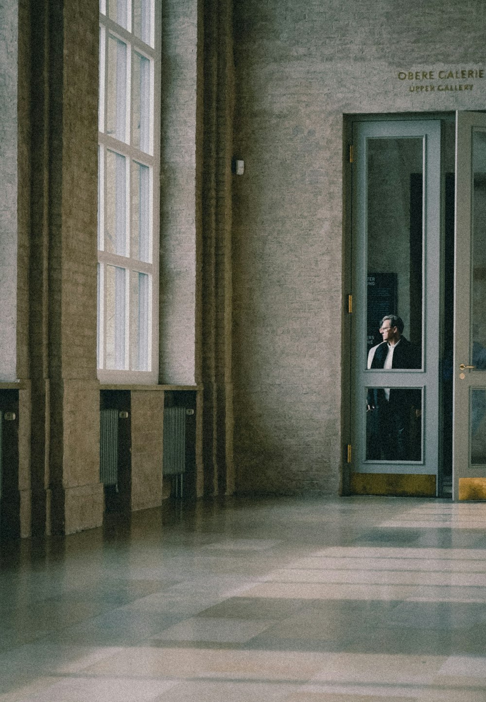 a man in a suit standing in a doorway