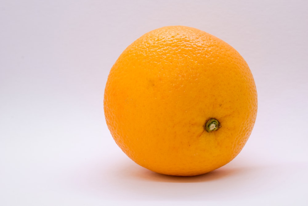 a close up of an orange on a white background