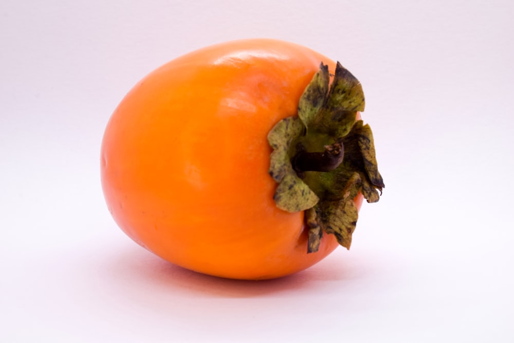 a close up of an orange on a white background