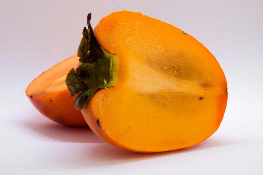 a close up of two oranges on a white background