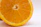 Close-up of a sliced mango showing its vibrant orange flesh on a rustic wooden table.