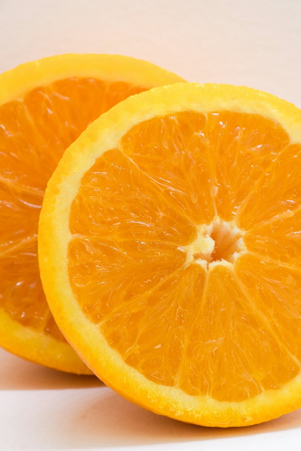two halves of an orange on a white background