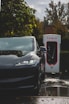 a tesla electric car plugged in to a charging station