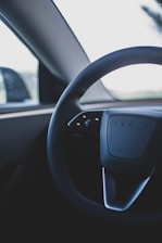 a car dashboard with a steering wheel and a dash board
