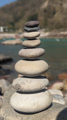 Smooth river stones neatly stacked to create a garden border.