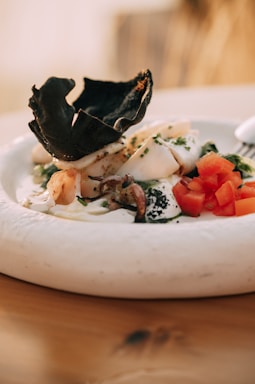 A beautifully arranged seafood platter featuring grilled fish, shrimp, and octopus with fresh garnishes.