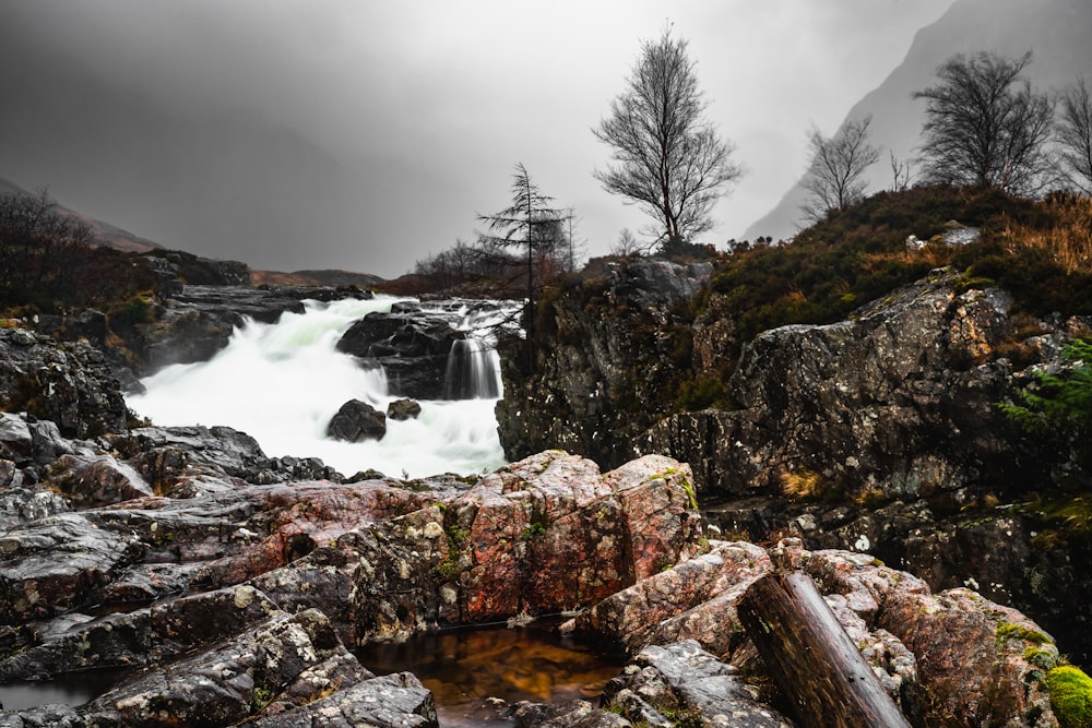 a waterfall in the middle of a rocky area