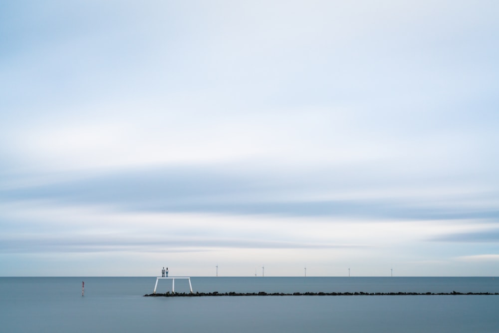 a large body of water sitting under a cloudy sky