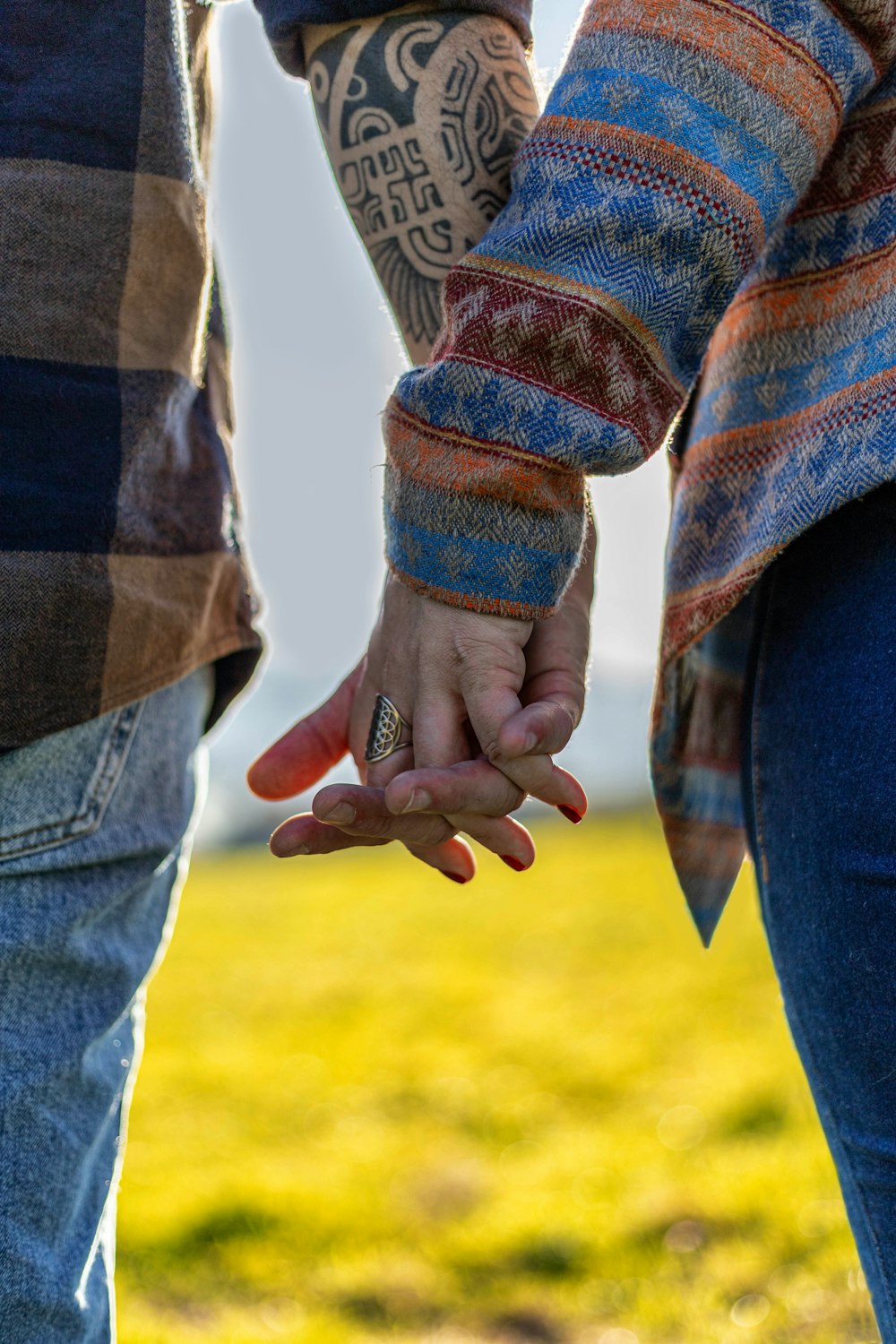 a close up of two people holding hands