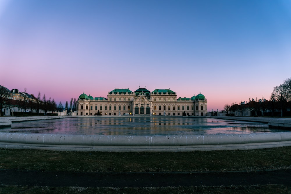 a large building with a fountain in front of it