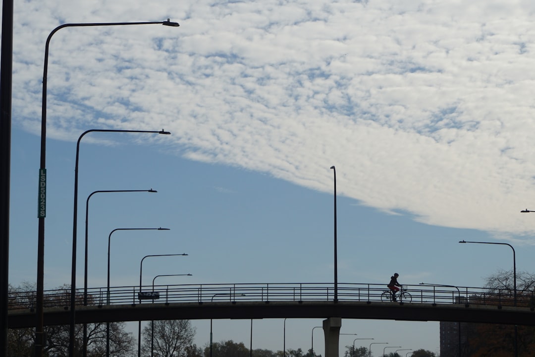 a person riding a bike across a bridge,