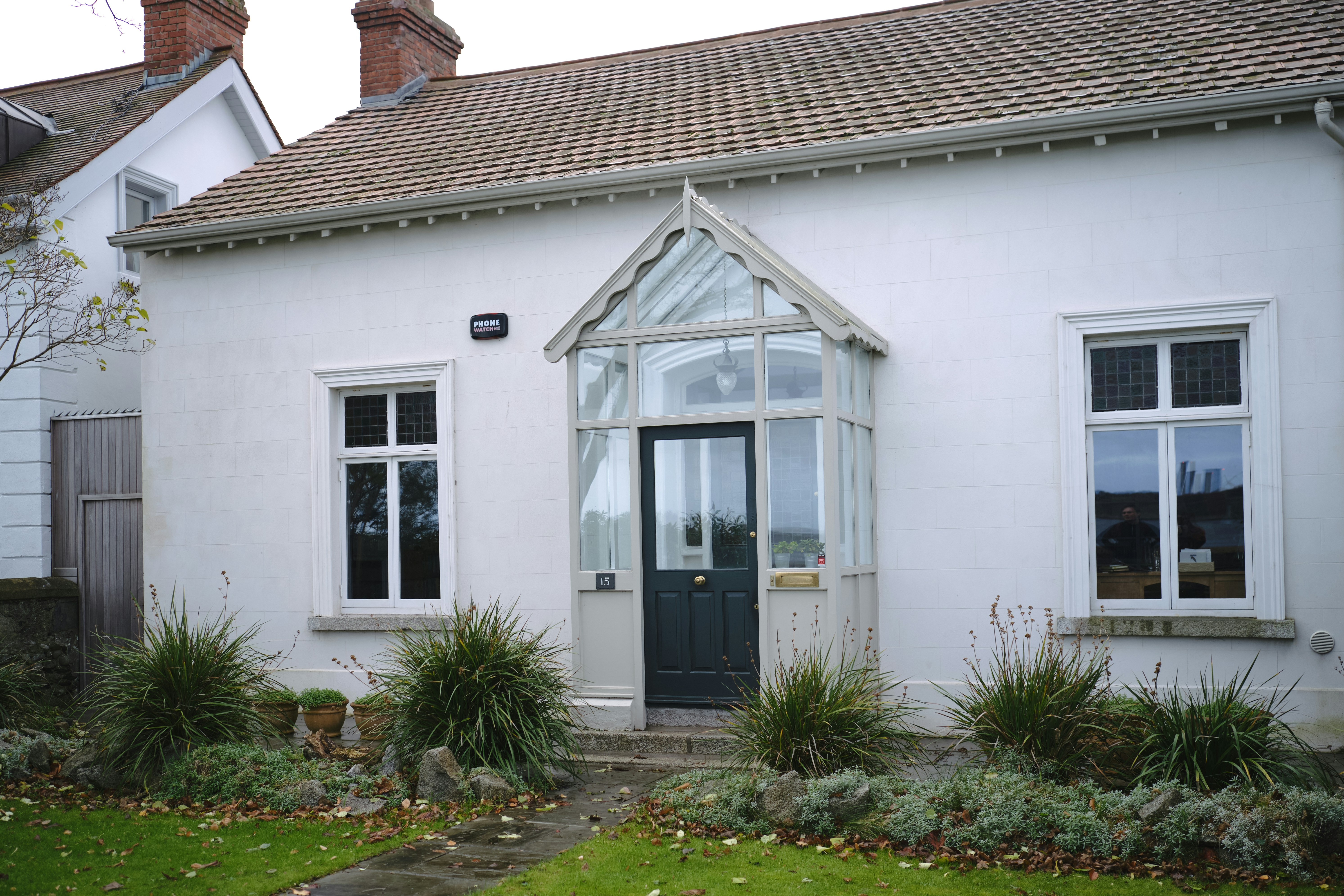 a white house with a black door and windows