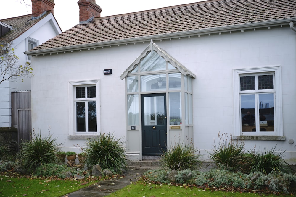 a white house with a black door and windows