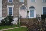 Before and after shot of a home's entrance transformed with new doors and fresh plastering.