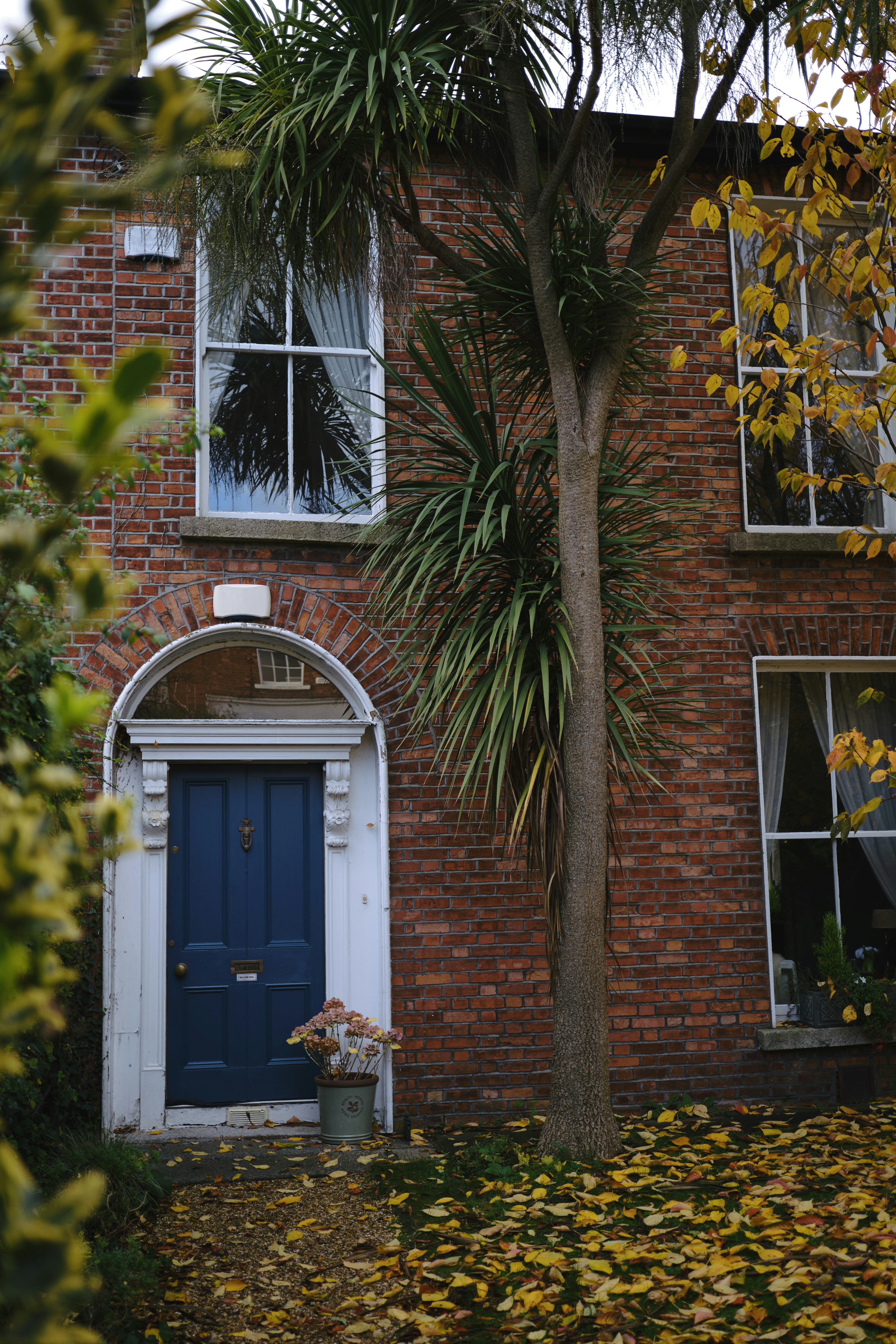 a brick building with a blue door and window