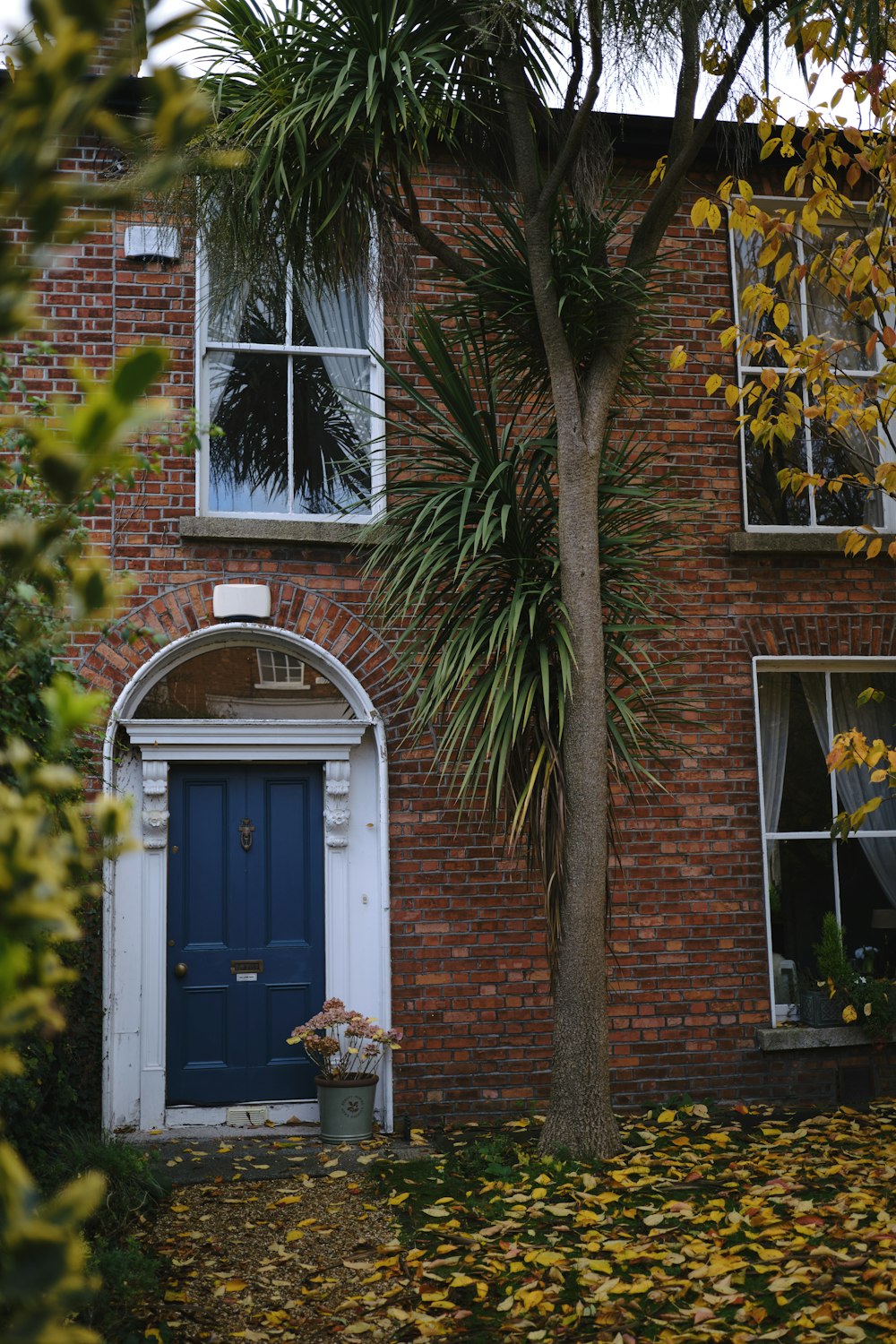 a brick building with a blue door and window