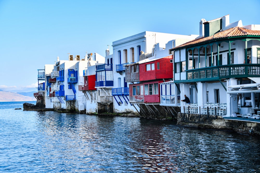 a row of houses on the edge of a body of water