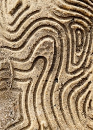 a close up of a pattern in the sand