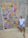 A man receiving guided physiotherapy exercises surrounded by colorful abstract wall art.