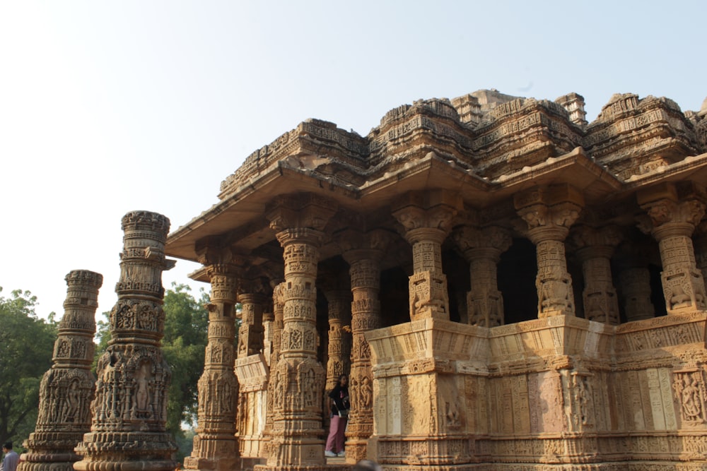 a group of stone pillars in front of a building