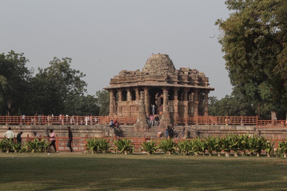 a group of people standing in front of a stone structure