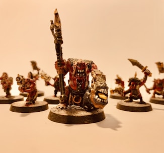 Close-up of a finely painted miniature hero figure with dynamic lighting.