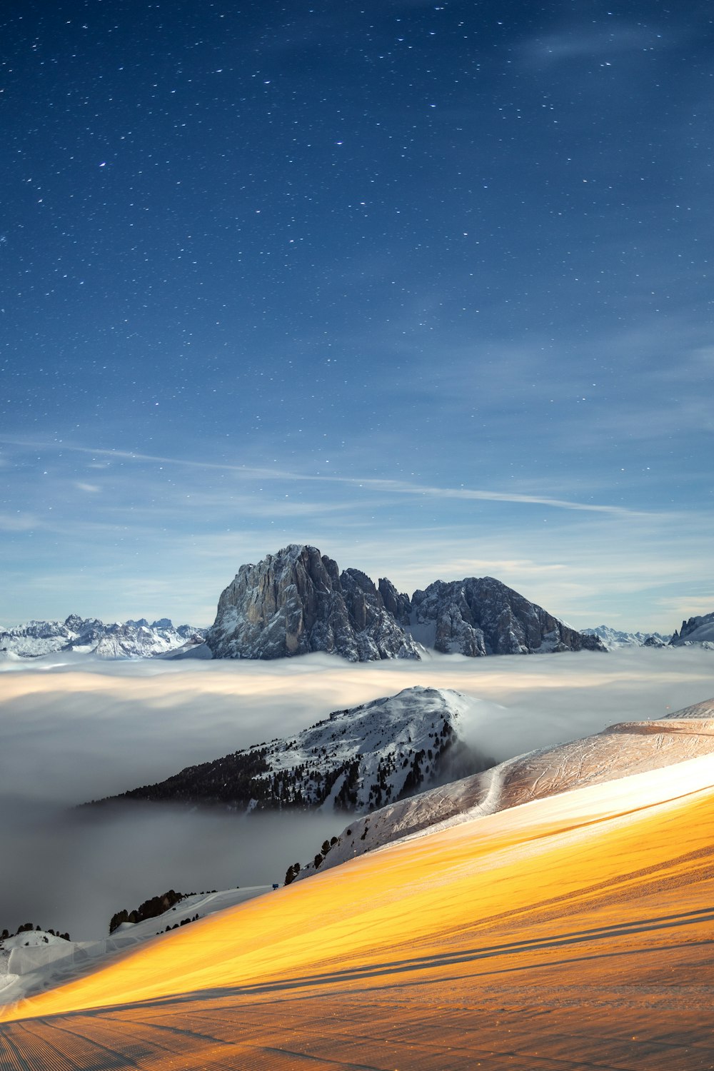 a mountain covered in snow under a night sky