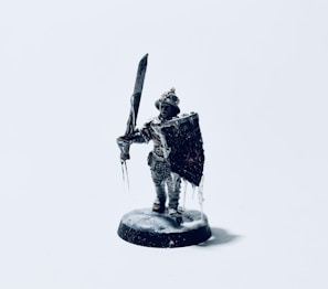 A 3D printable miniature of a heroic knight poised for battle, finely detailed.