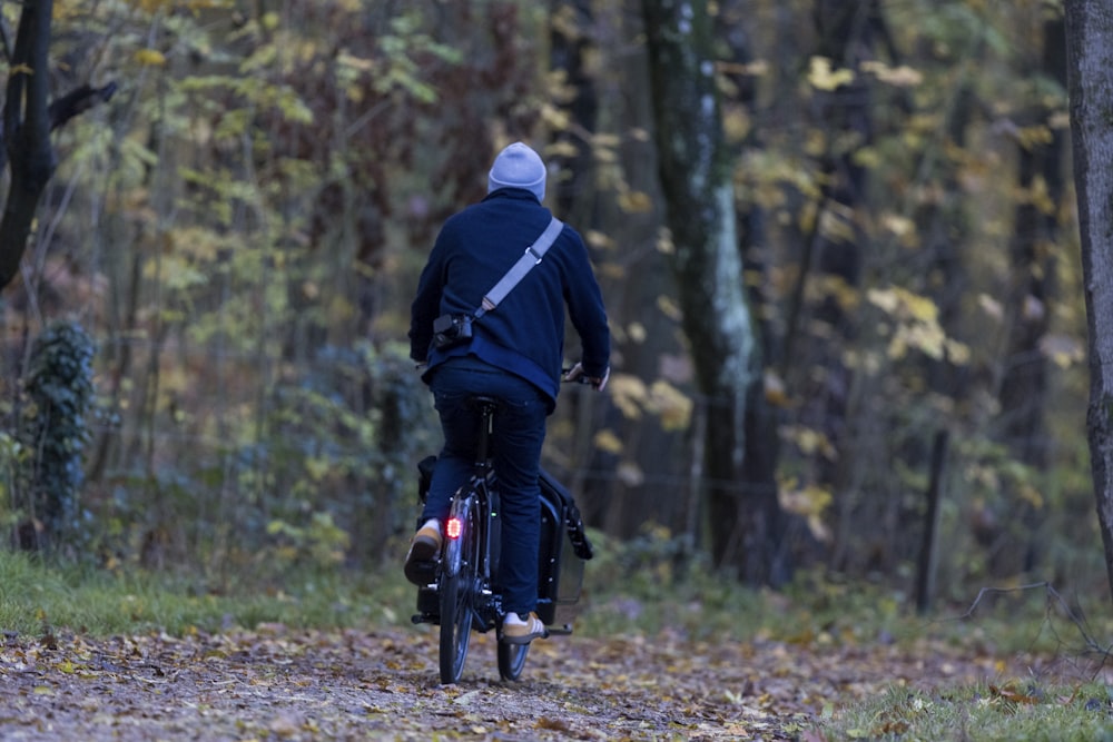 a person riding a bike in the woods