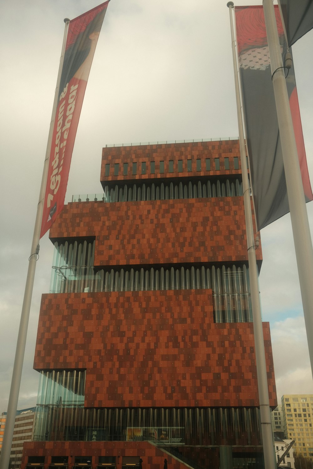 a red brick building with two flags in front of it