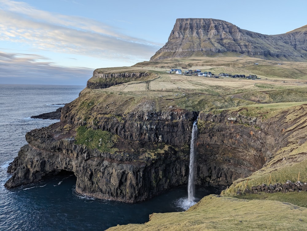 a large waterfall in the middle of a large body of water