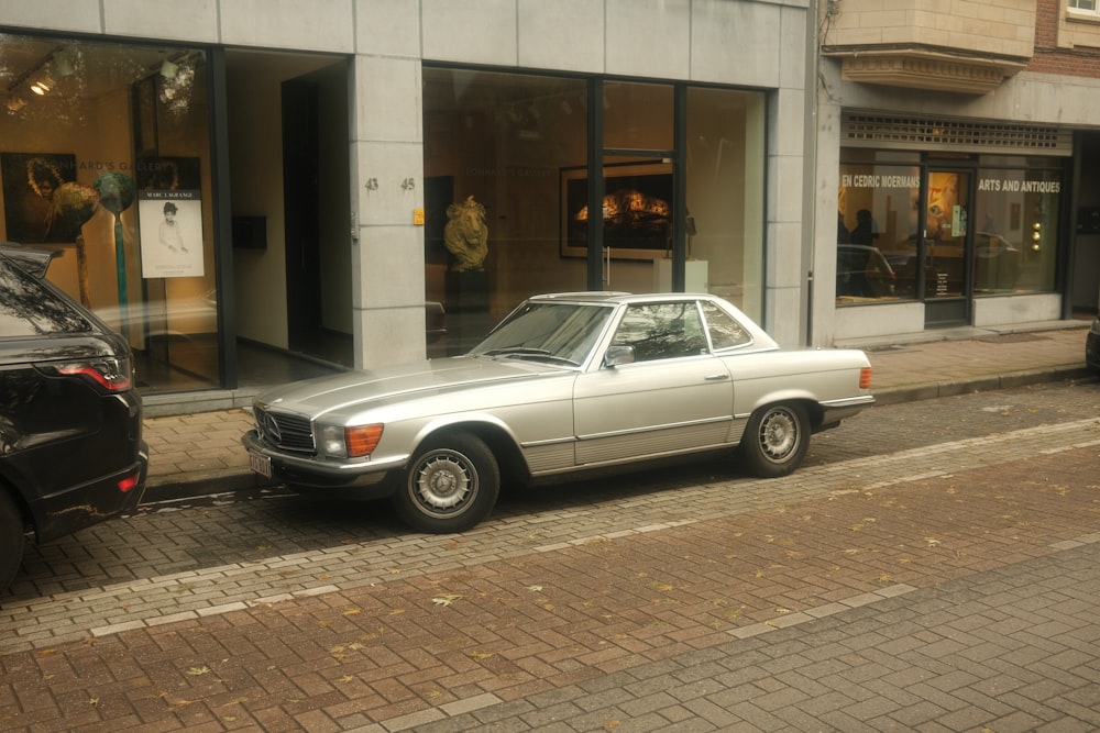 a silver car parked on the side of a street