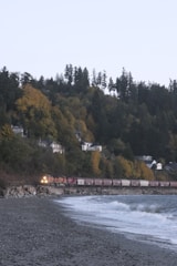 A freight vehicle transporting goods along a coastal highway.