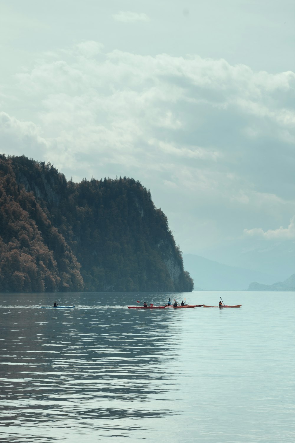 a group of people in canoes paddling on a large body of water
