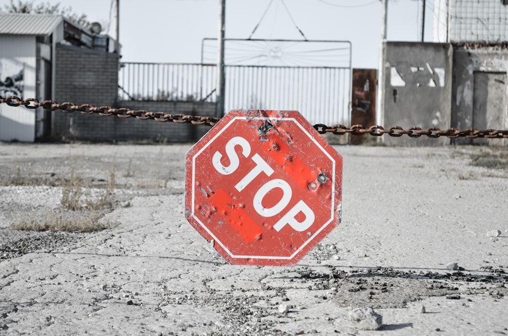 a red stop sign sitting on the side of a road