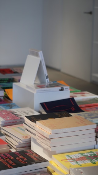 Close-up of various book binding types displayed on a wooden table.