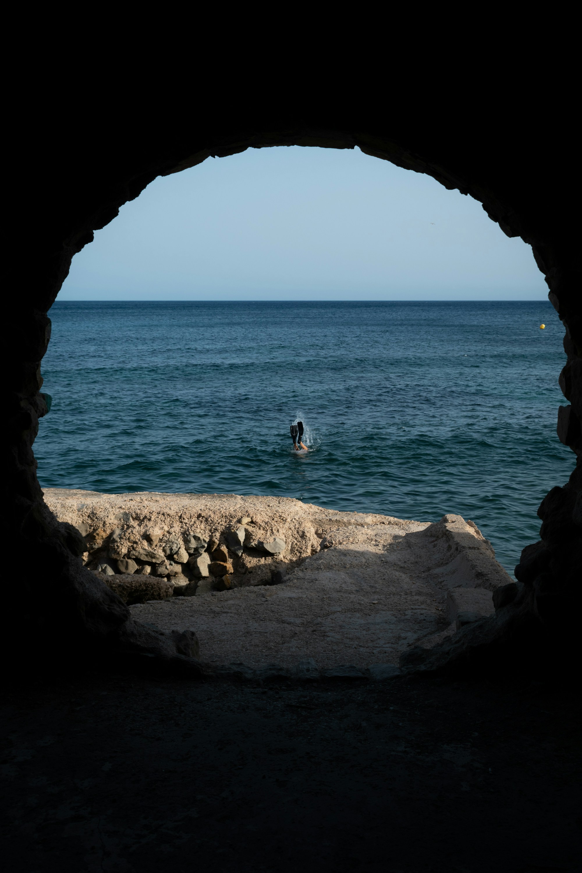 a view of a body of water from a cave