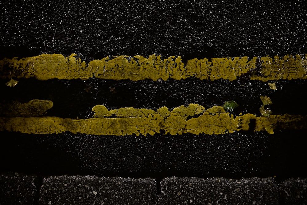 a yellow line painted on the side of a road