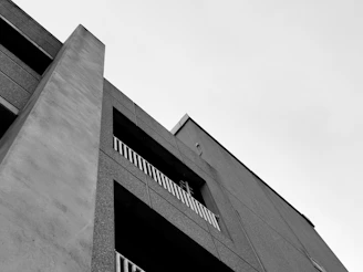 Crisp photo of a finished residential build with clean lines and a charcoal gray and construction orange color scheme.