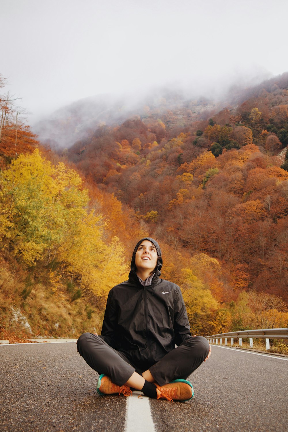 a person sitting in the middle of a road