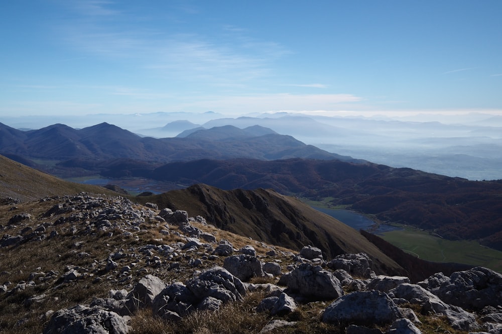 a view of a mountain range with a lake in the distance