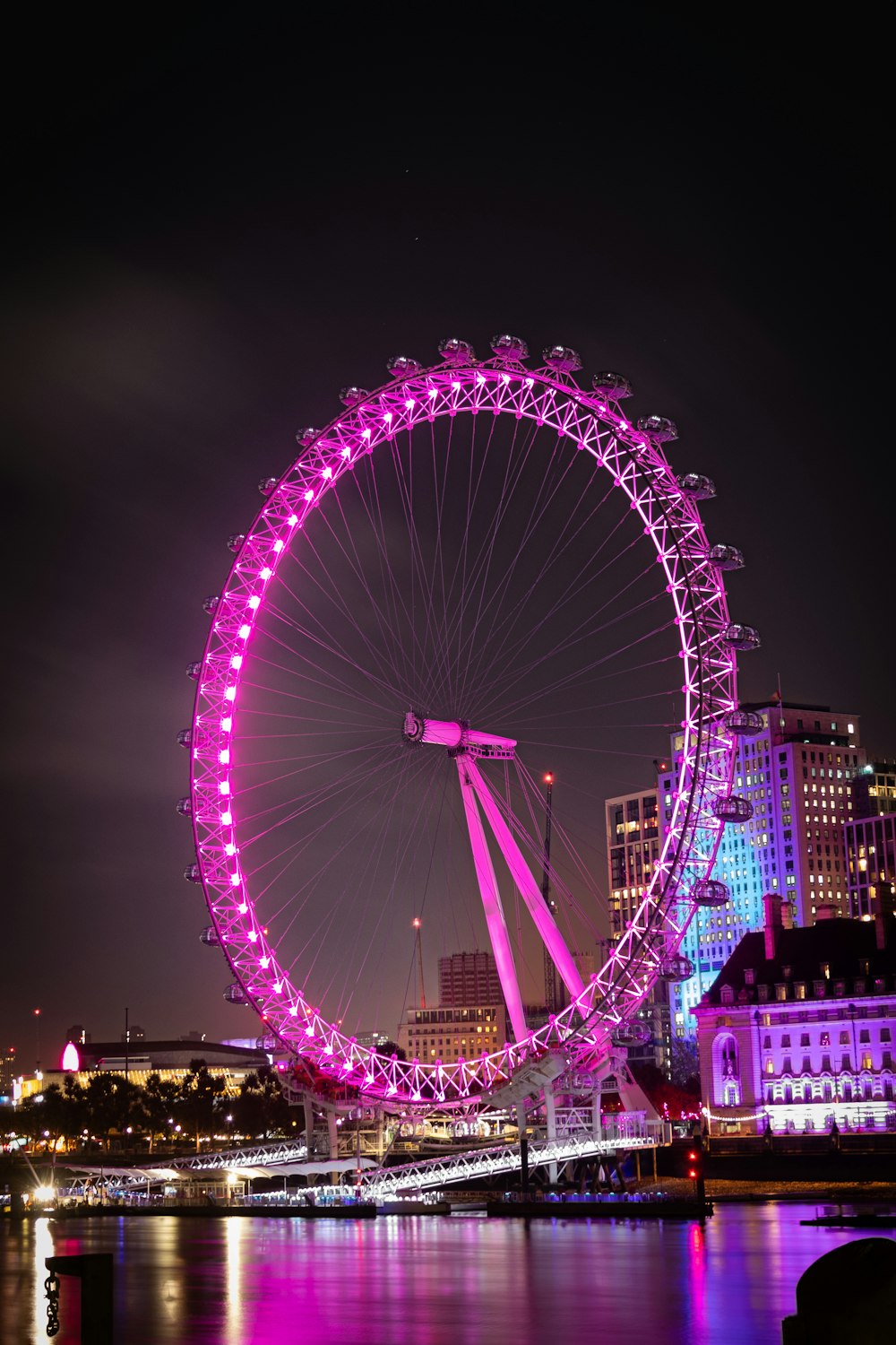 a ferris wheel lit up in the night sky