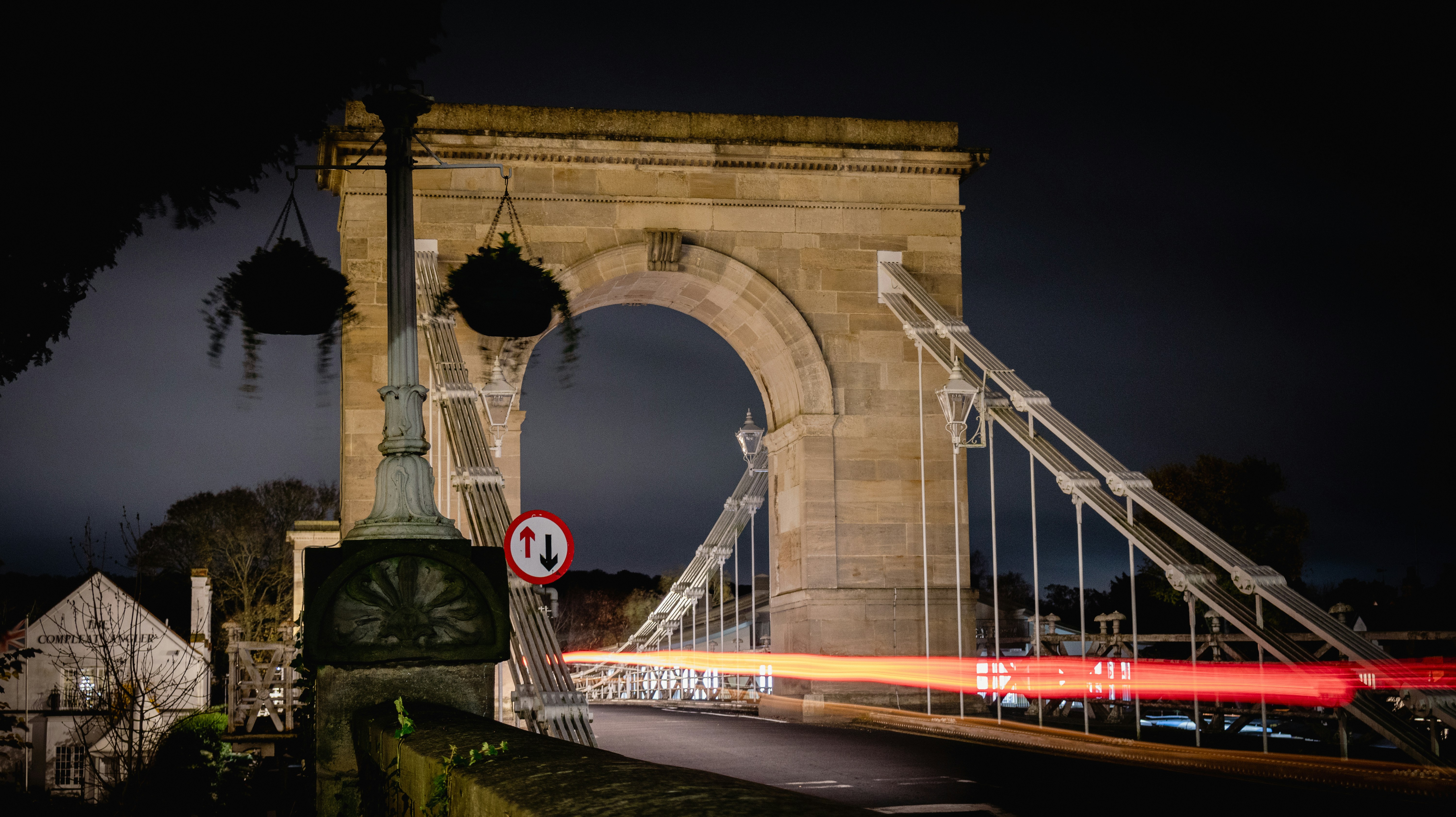 a very tall bridge with a clock on it's side
