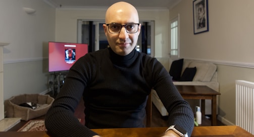 A friendly technician discussing home maintenance plans with a homeowner in a cozy living room.