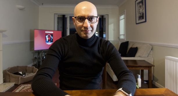 A friendly technician assisting a homeowner inside a cozy living room.