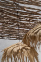 Artistic wooden wall hanging with natural patterns and warm tones.