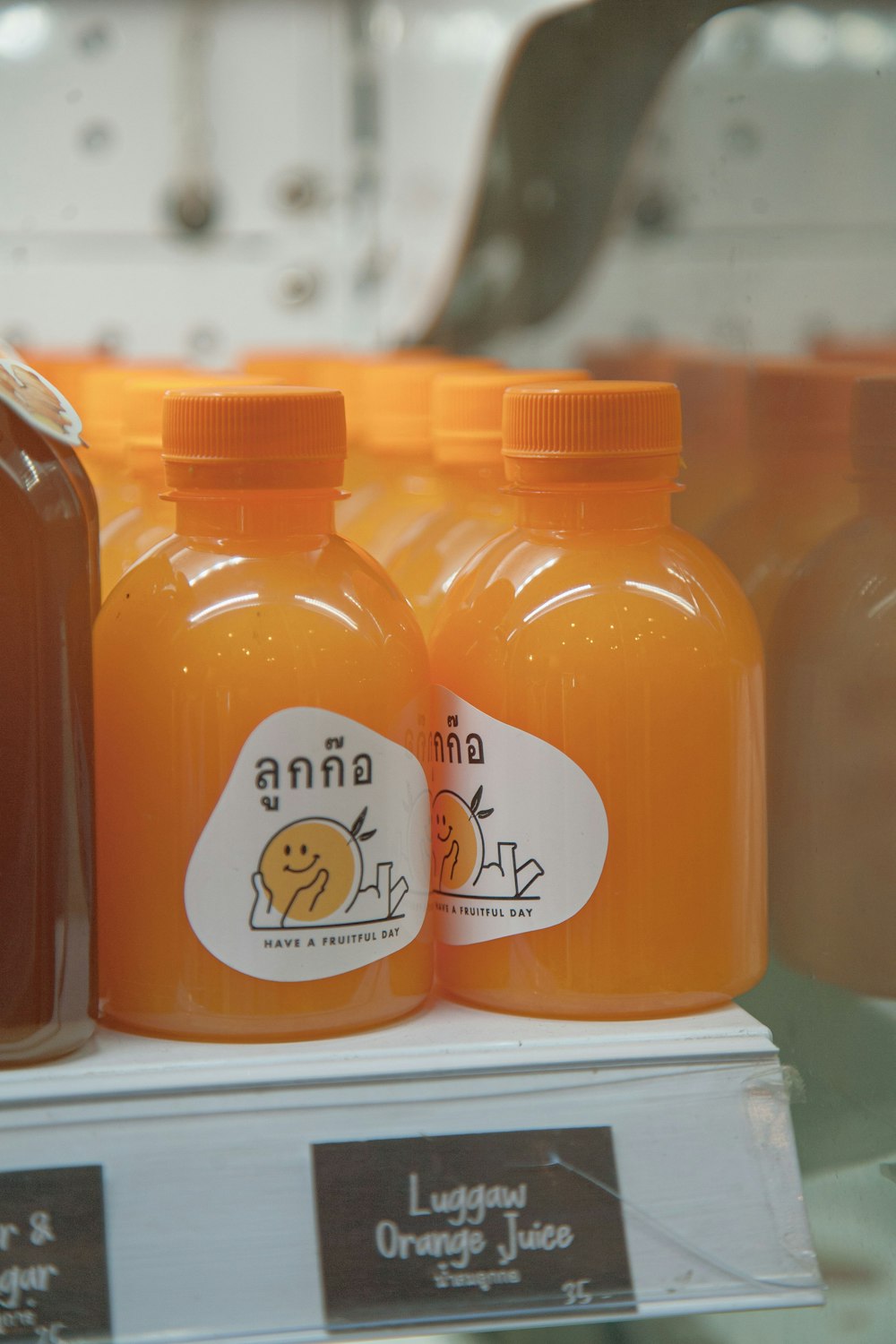 bottles of orange juice on display in a store