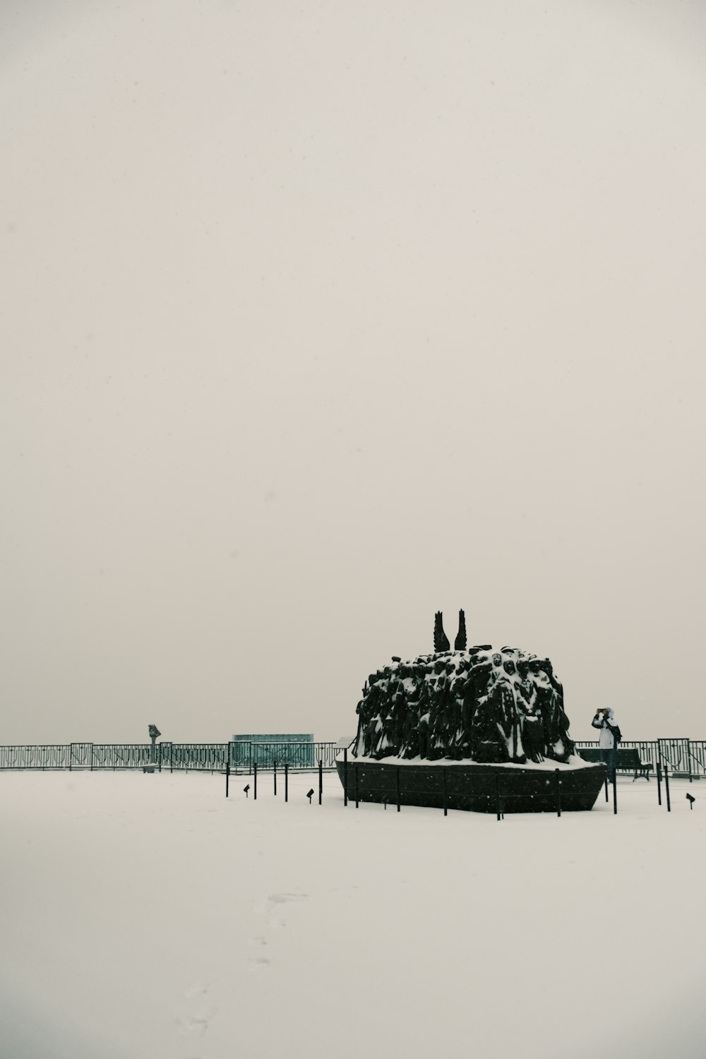 a snow covered boat sitting on top of a snow covered beach